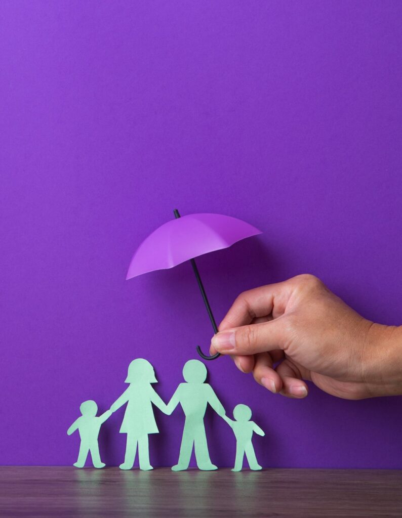 Hand holding a small purple umbrella.